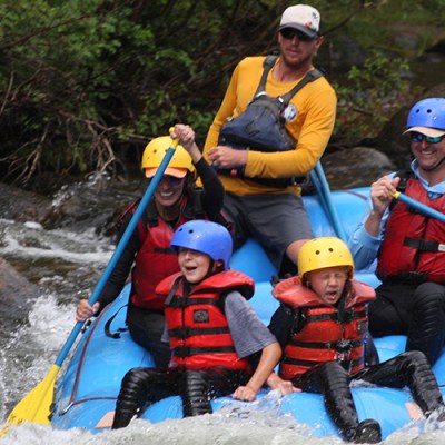 A family rafting in the cold water in Gunnison, Coloraod