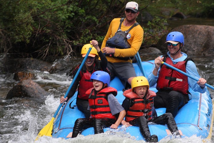 A family rafting in the cold water in Gunnison, Coloraod